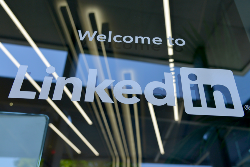 Welcome to LinkedIn sign on a glass door.