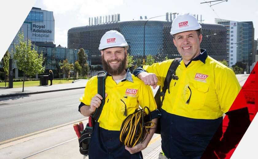 Electrical contractors, supplied by RED Appointments smile in front of Adelaide Hospital.